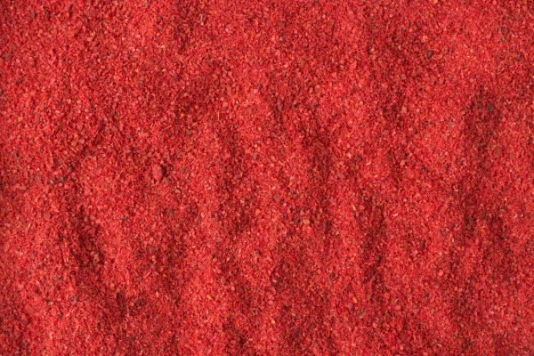 texture of hot chili pepper powder close-up, spice or seasoning as background