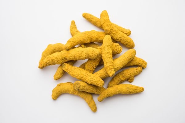 Dried Turmeric Roots or sookhi Haldi as a whole on white background, selective focus