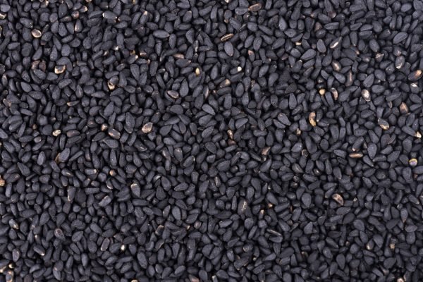 Black cumin seeds background. Nigella sativa. Top view